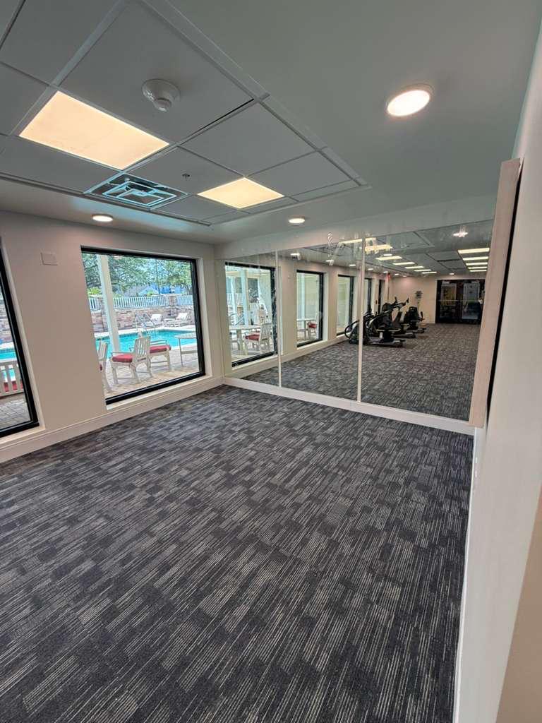 Large wall mirror installation in fitness room