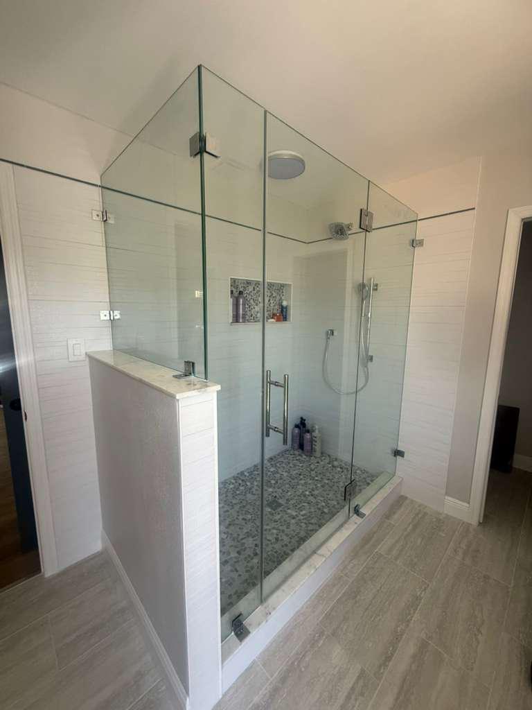 Frameless shower glass enclosure installation