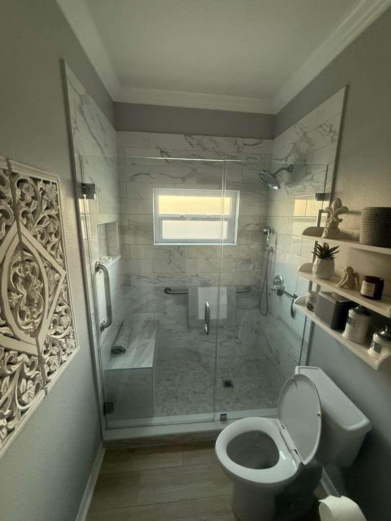 Shower glass panel installation in small bathroom