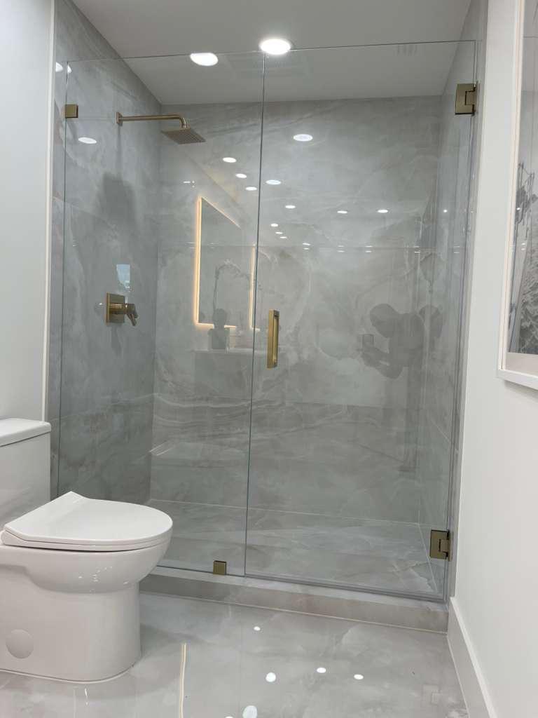 Gold hardware shower glass enclosure