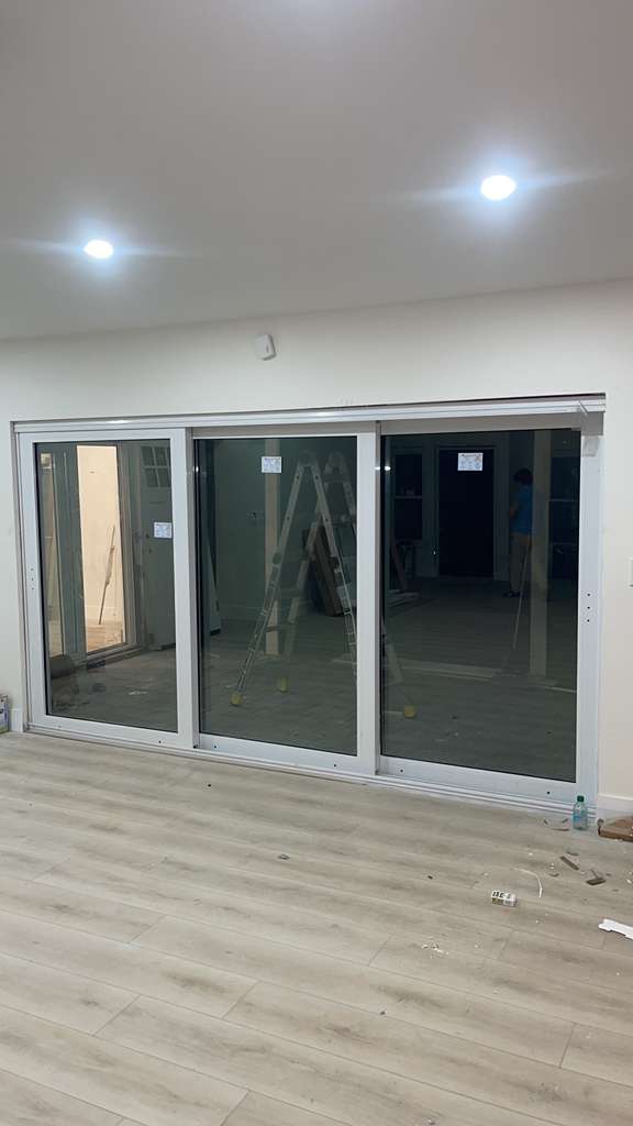 White three-panel sliding glass door replacement