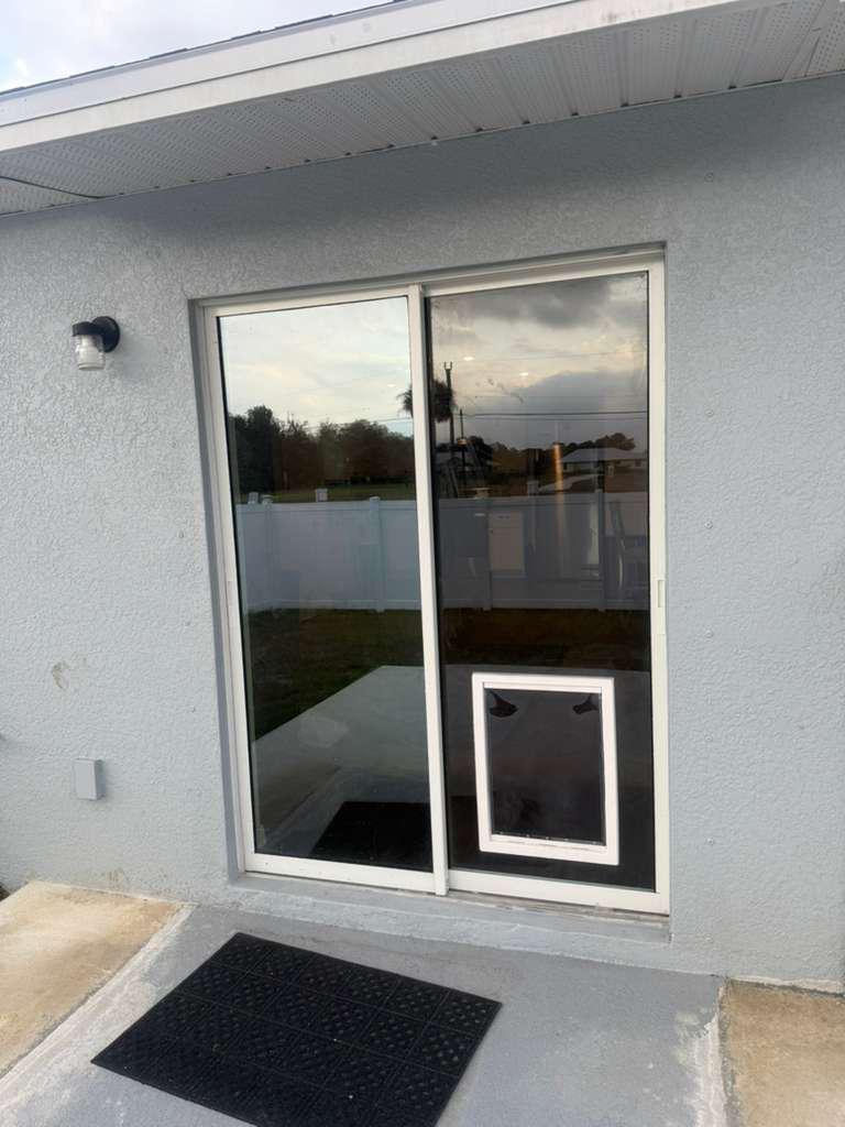 Sliding glass door repair with pet door insert