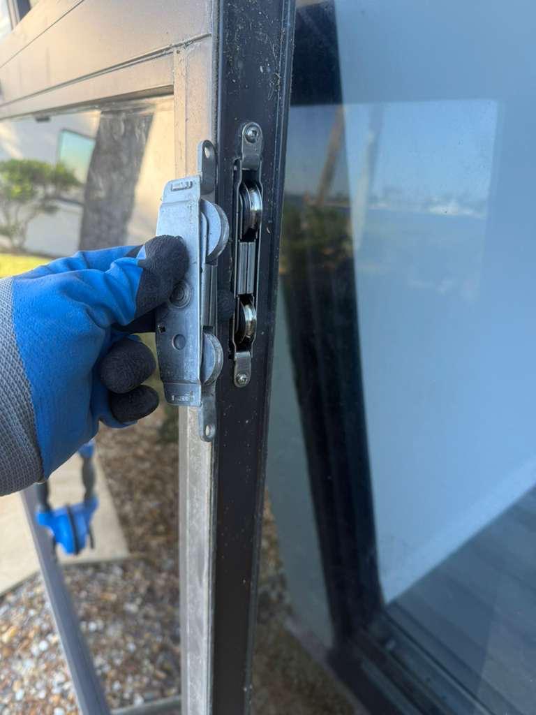 Replacement rollers aligned inside sliding door frame