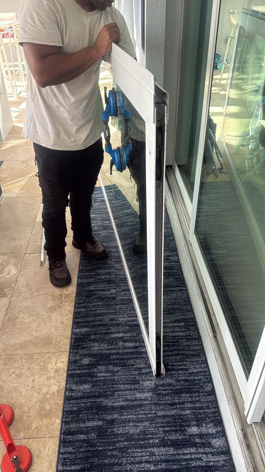 Sliding door panel lifted for roller replacement